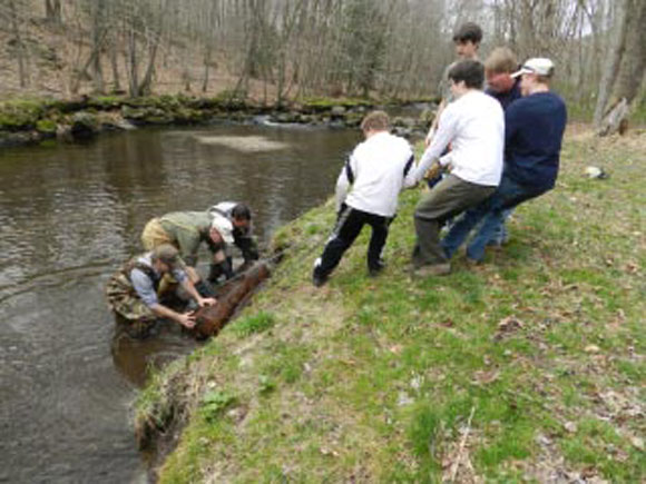 Scouts and volunteers, organized by Eagle Scout Eric Rasmussen, remove refuse from the Halfway River during spring of 2012