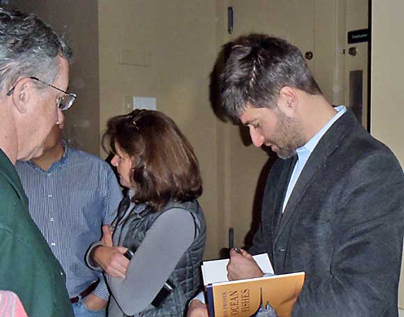 James Prosek signs copies of his book "Ocean Fishes" at Nutmeg TU's holiday party last December. A documentary on eels by the local resident will premiere on the PBS series "Nature" Wednesday, April 17.