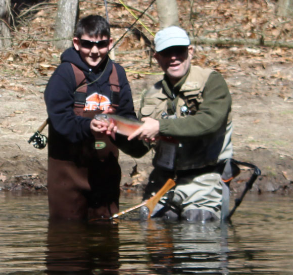 Ryan Welsh and David Ader, who netted the fish, display Ryan's first trout and first fish on the fly rod during a Nutmeg TU outing in the Doc Skerlick Area of the Saugatuck River on March 31.